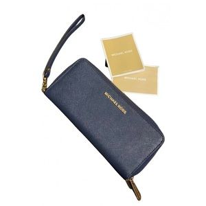 Navy Michael Kora wallet, used but comes with the original tags!